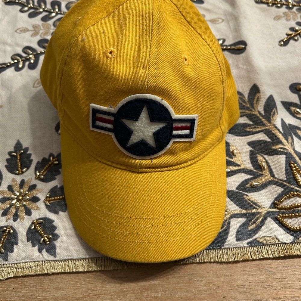 Red Canoe National HeritageYellow Cap with military Emblem